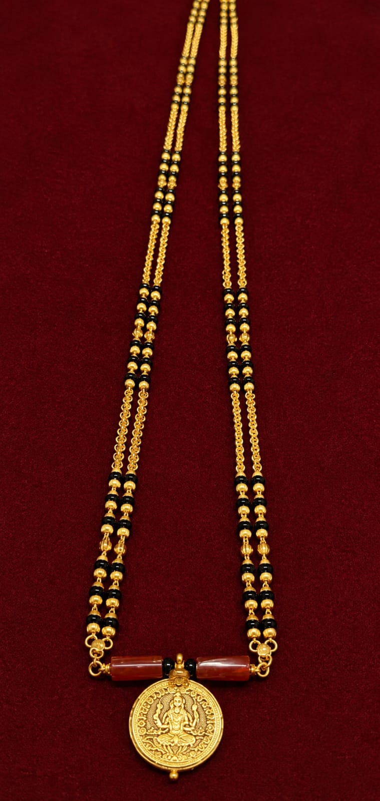Woman wearing a gold necklace from the  NewManaka collection